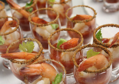 Mini shot glasses filled with shrimp and cocktail sauce